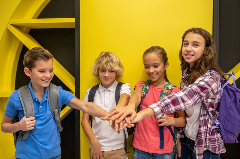 group-two-boys-girls-laying-their-hands-together